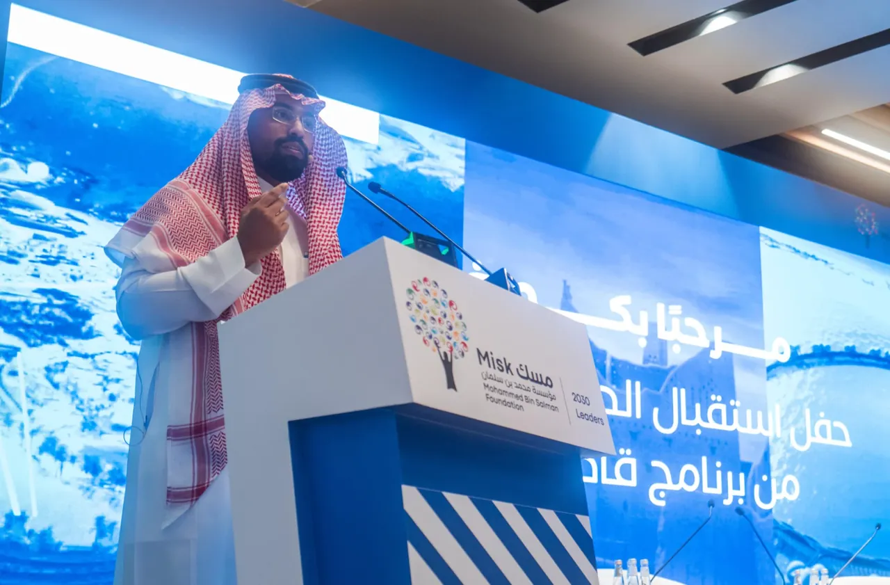 Speaker presenting to an audience from the Misk podium